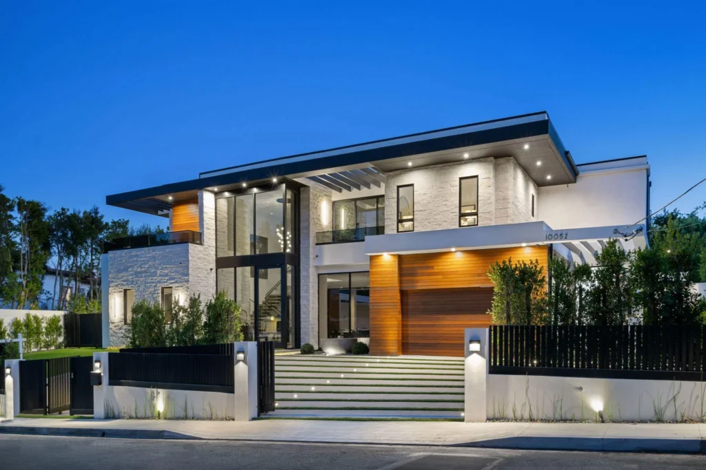 Luxury modern home turnkey project with stone and wood cladding at blue hour