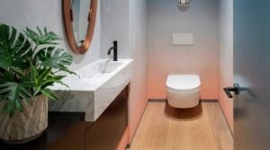 Modern bathroom with floating vanity and copper mirror at Globe Residency Karachi