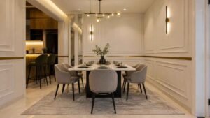 Elegant dining area with grey chairs and gold pendant lights at Globe Residency Karachi