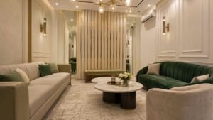 Elegant lounge with beige and green sofas at Globe Residency Karachi