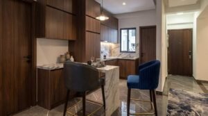 Modern kitchen with breakfast bar and blue chairs at Globe Residency Karachi