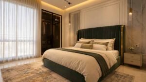 Master bedroom with dark green headboard and wardrobe at Globe Residency Karachi