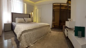 Bright bedroom with patterned bedding and wardrobes at Peace Apartments Karachi