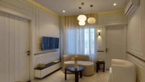 Modern living room with TV wall and white panels at Peace Apartments Karachi