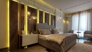 Master bedroom with gold accent panels and modern lighting at Peace Apartments