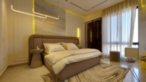 Luxury master bedroom with warm LED lighting and marble feature wall at Peace Apartments Karachi
