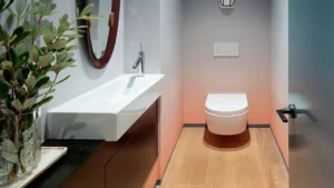 Modern bathroom with floating wooden vanity and plants at Peace Apartments Karachi
